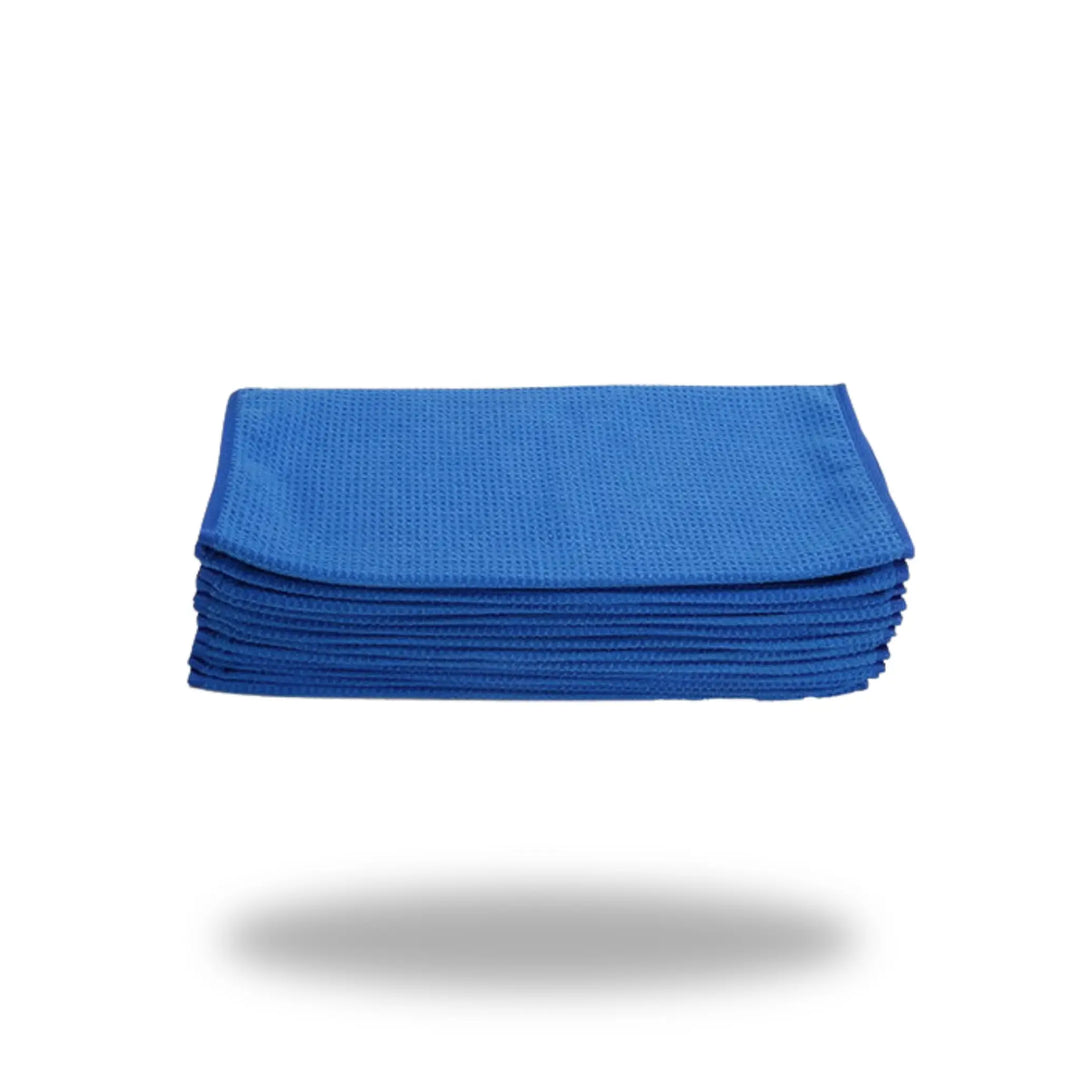 Stack of blue waffle weave cleaning cloths isolated on white background labeled Blue Waffle Weave Ultra Glass