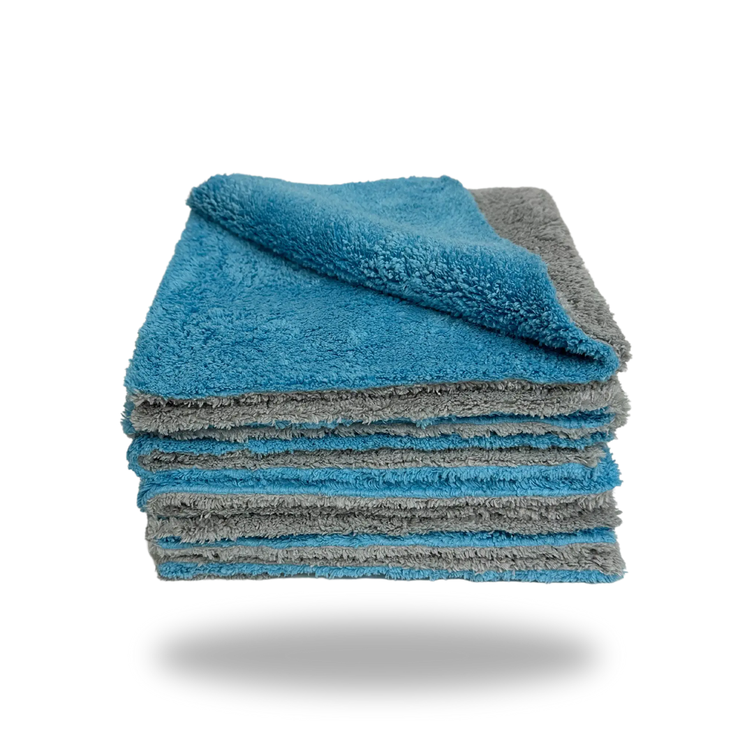Stack of soft blue and gray Edgeless Dual-Faced Microfiber cloths with one corner folded to show both sides