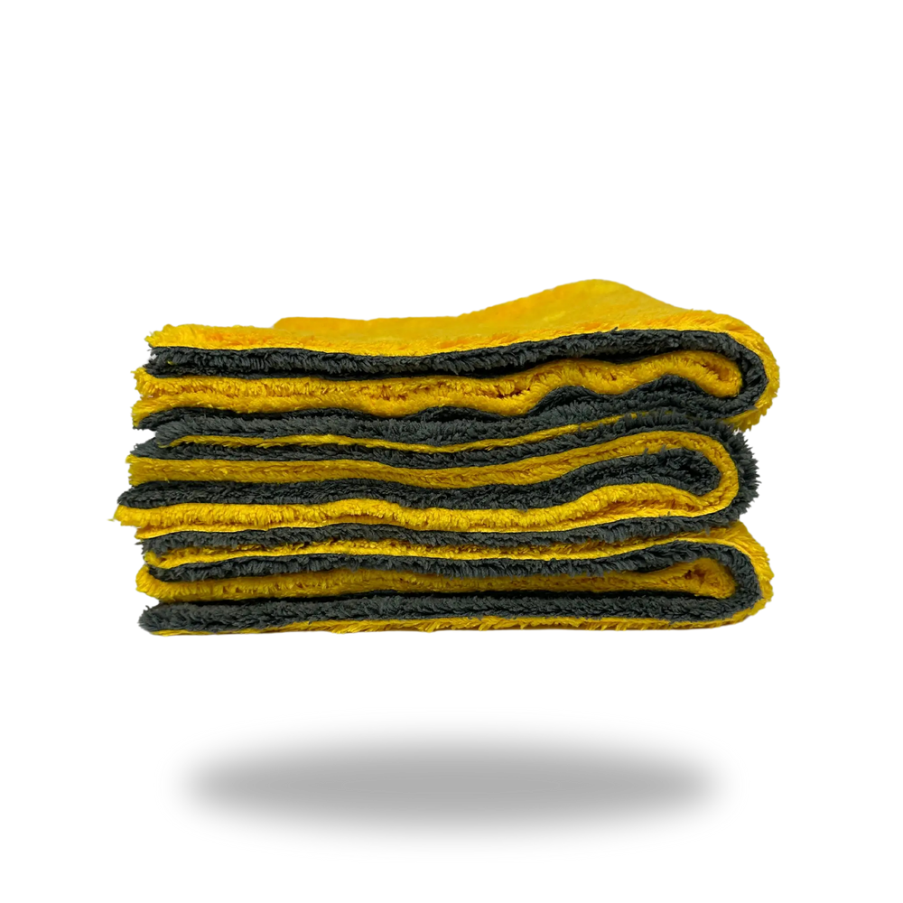 Folded yellow and gray Edgeless Dual-Faced Microfiber cloth showing soft texture and layered edges.