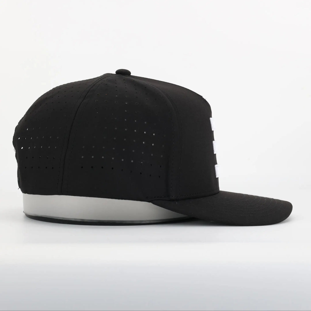 Finish Line Series Hat - Black showing side view with perforated breathable fabric and flat brim design.
