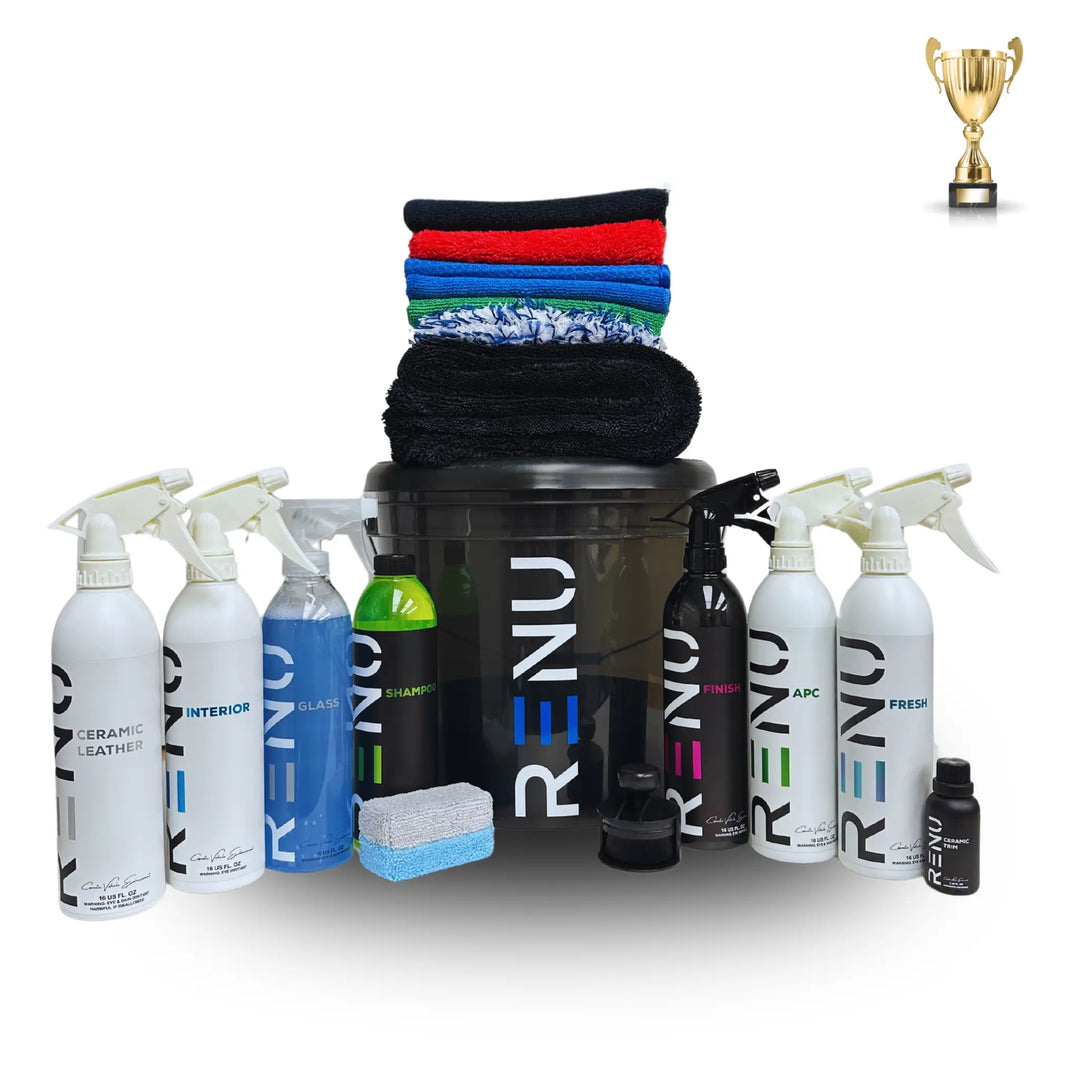 Gold Car Care Kit with multiple cleaning sprays, microfiber towels, brushes, and a black bucket for car detailing.