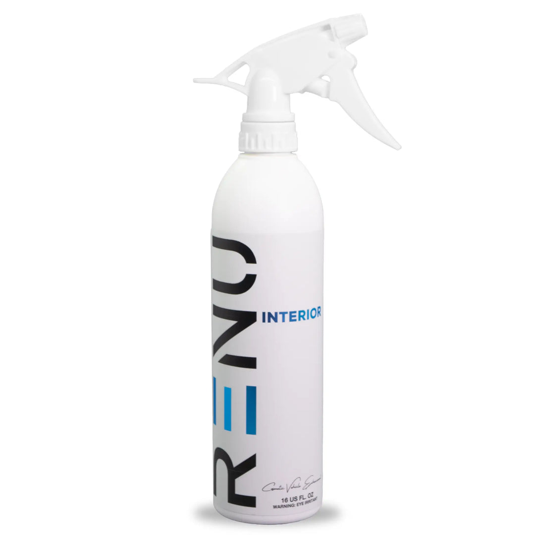 White spray bottle labeled INTERIOR for cleaning or refreshing indoor surfaces with trigger nozzle design