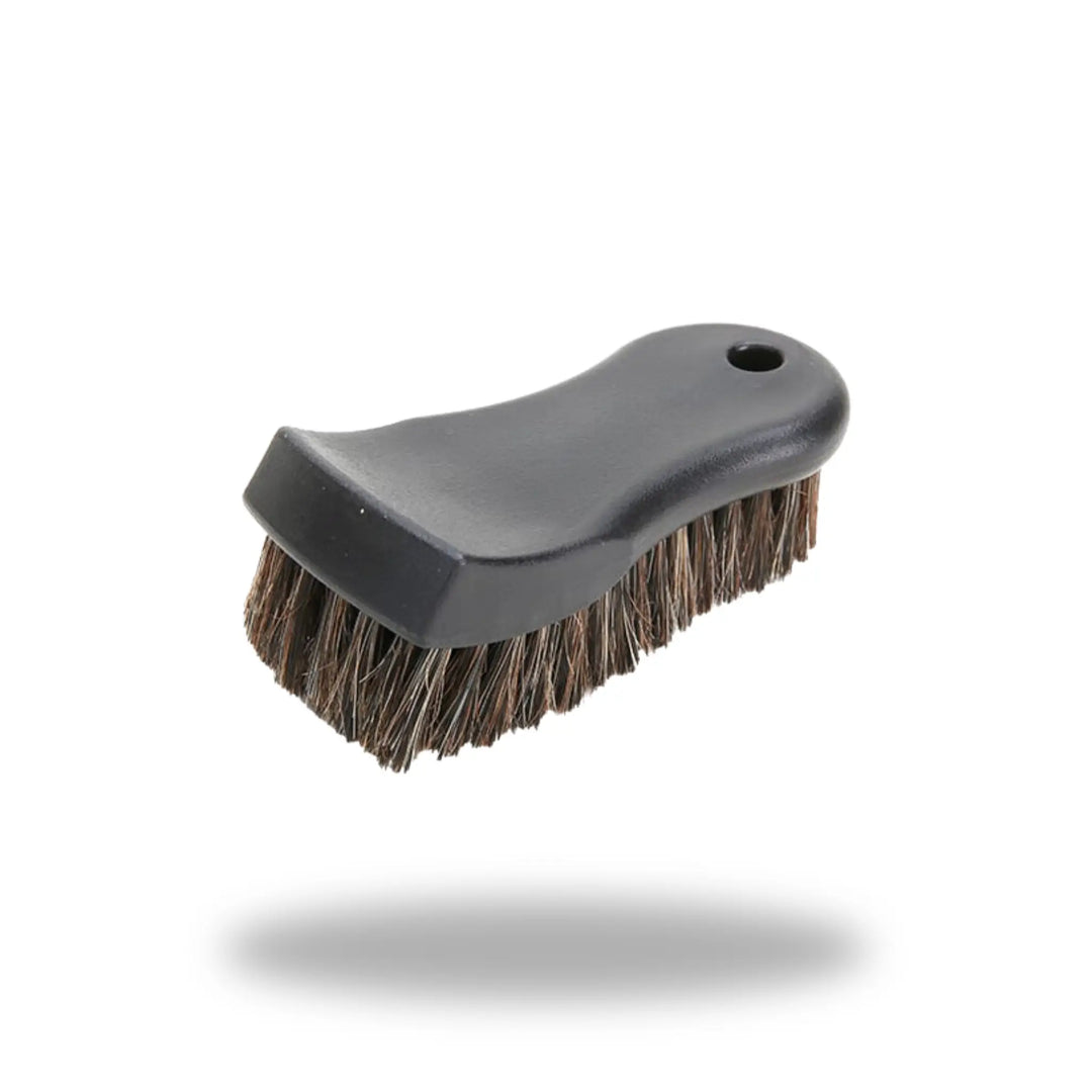 Compact black handheld Leather & Upholstery Cleaning Brush with dense bristles and ergonomic handle.