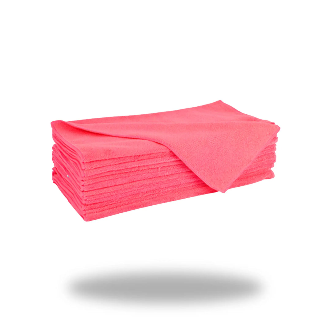 Stack of folded bright red cleaning cloths made of Red Ultra Microfiber fabric on white background