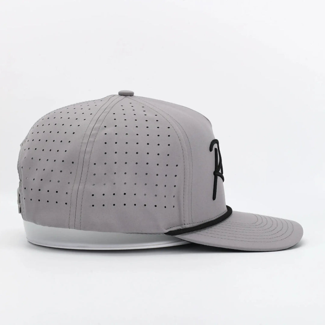Side view of a gray perforated cap with black detailing and Script Grey branding on the front panel