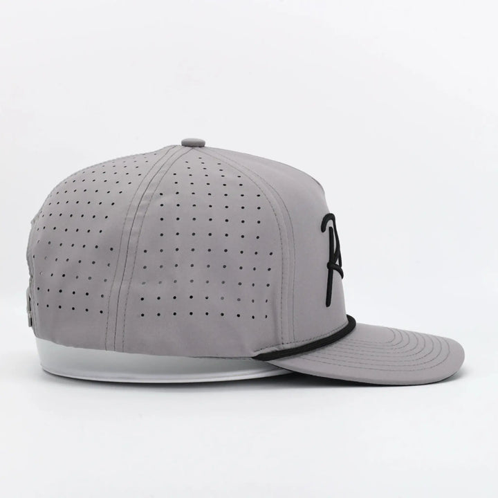 Side view of a gray perforated cap with black detailing and Script Grey branding on the front panel