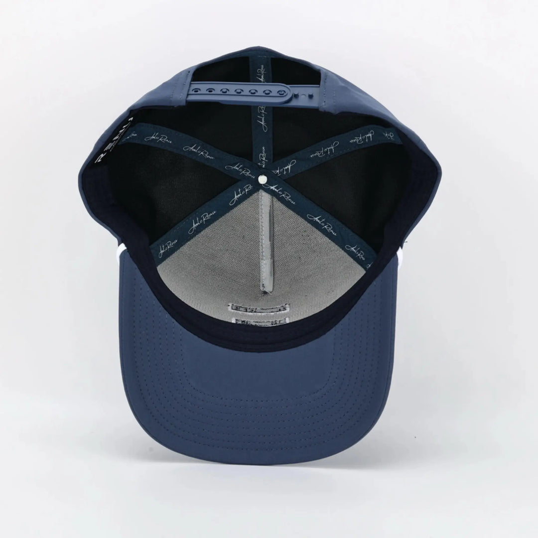 Interior view of a navy blue cap with adjustable strap, featuring Signature Blue branding on inner seams.