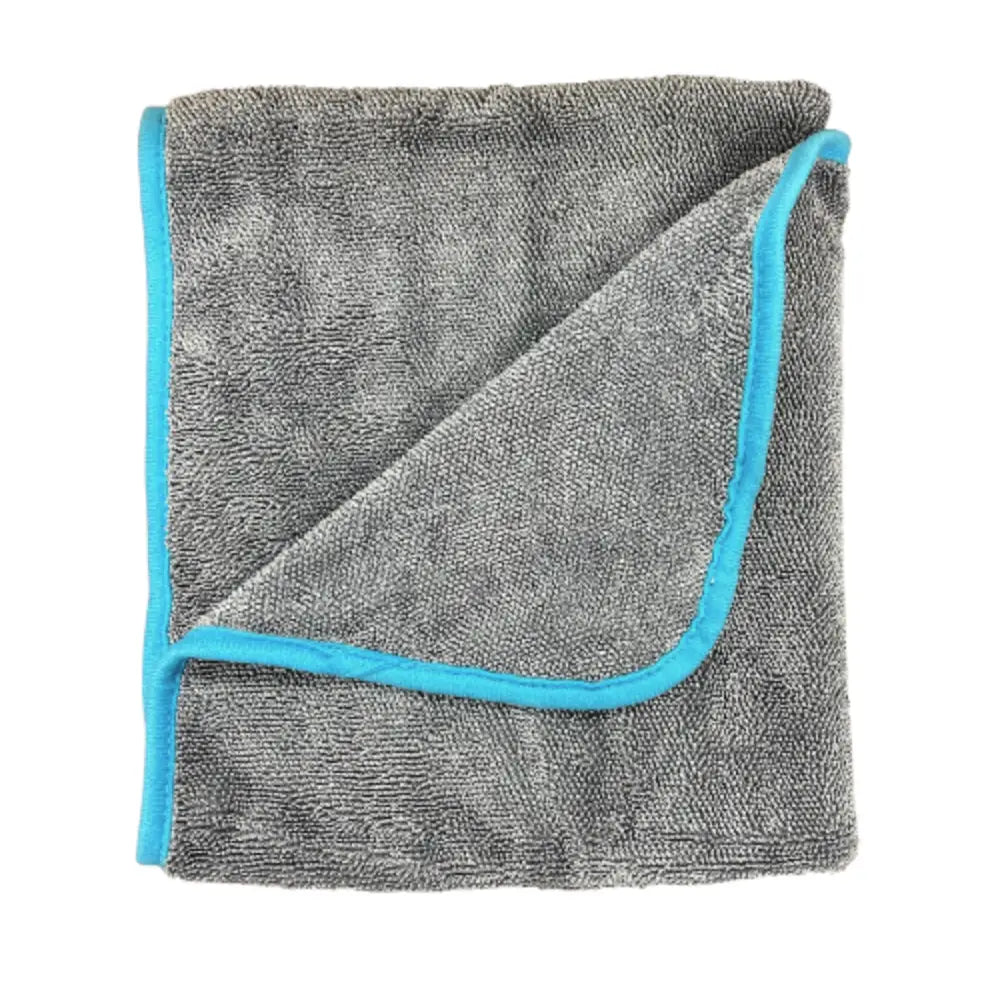 Folded gray microfiber towel with blue trim, called Twist 'n Dry Drying Towel, shown on a white background.