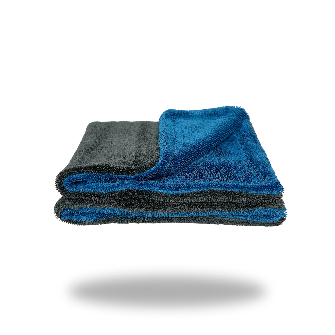 Folded blue and gray Twisted Loop Dual-Face Microfiber Drying Towel showing both textured sides and soft material layers